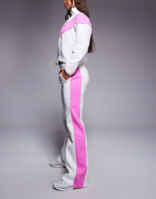 Windrunner track pants in off white and pink