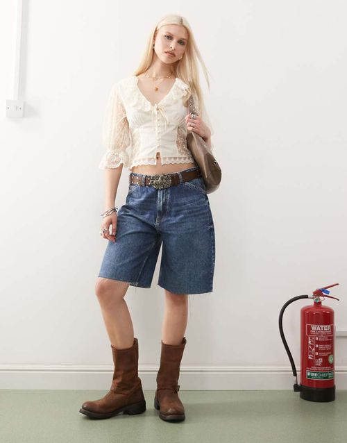 Reclaimed Vintage low rise baggy denim jorts in mid blue wash