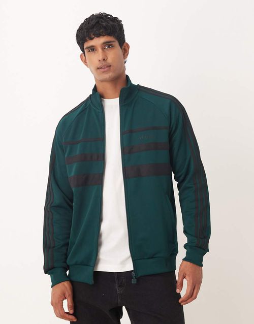 The First track top in dark green and black