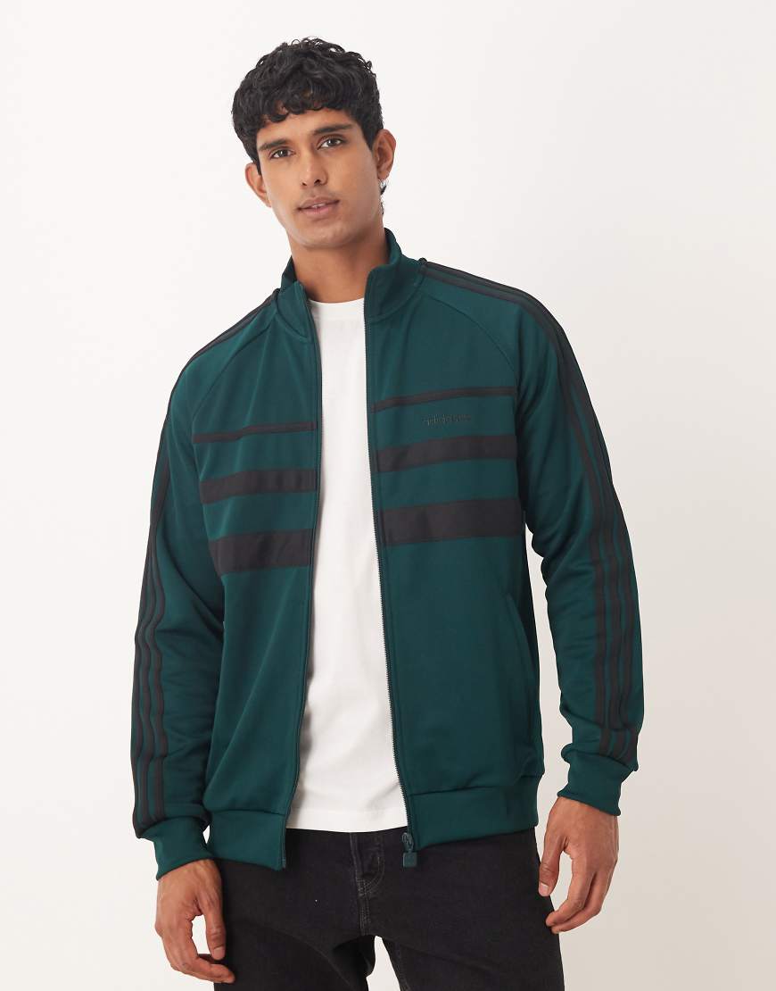 The First track top in dark green and black