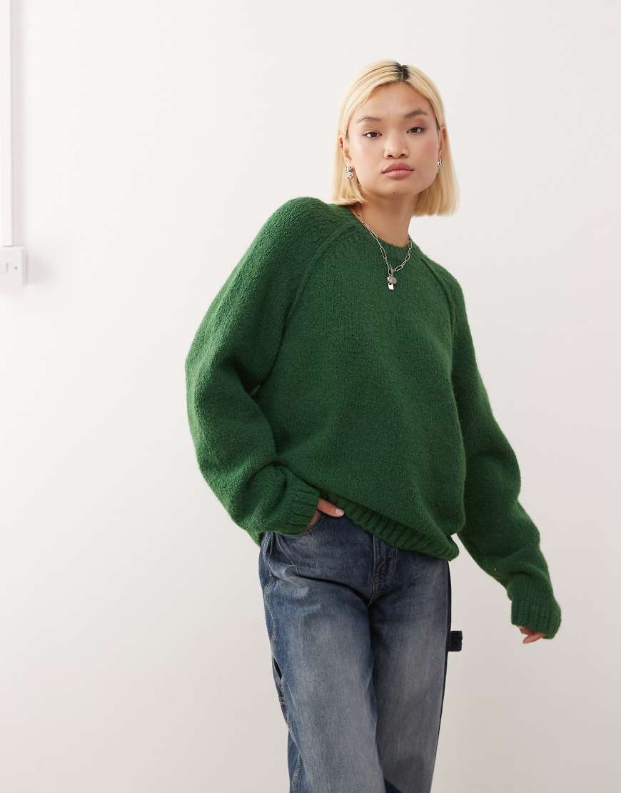 Oversized jumper in slub yarn with reversed seams in dark green