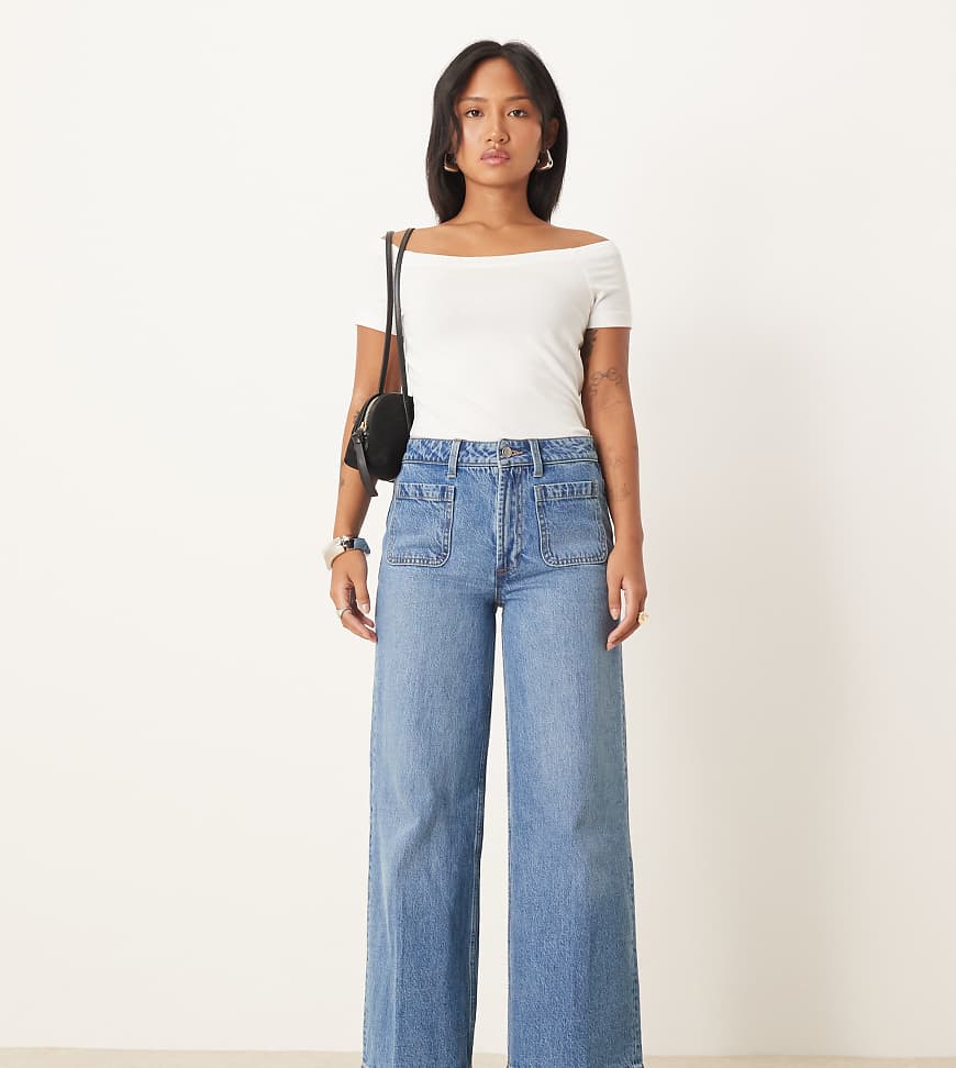 ASOS DESIGN Petite clean wide leg jeans with front pockets in mid blue