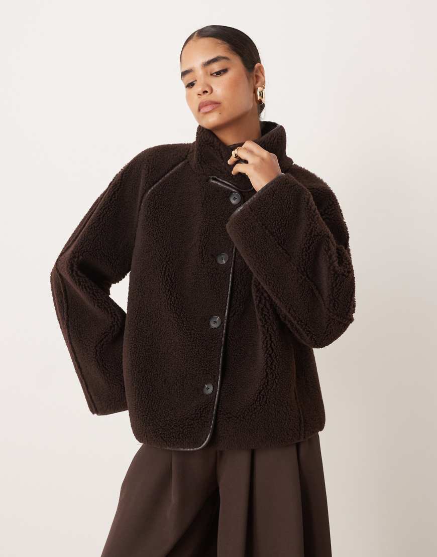 Oversized reversible borg jacket with high funnel neck in dark brown with edging
