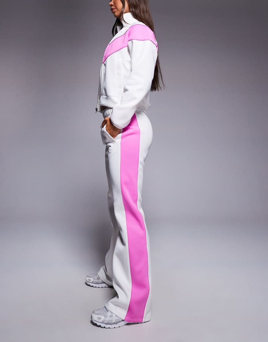 Windrunner track pants in off white and pink