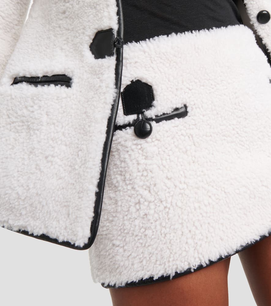 Leather-trimmed shearling miniskirt