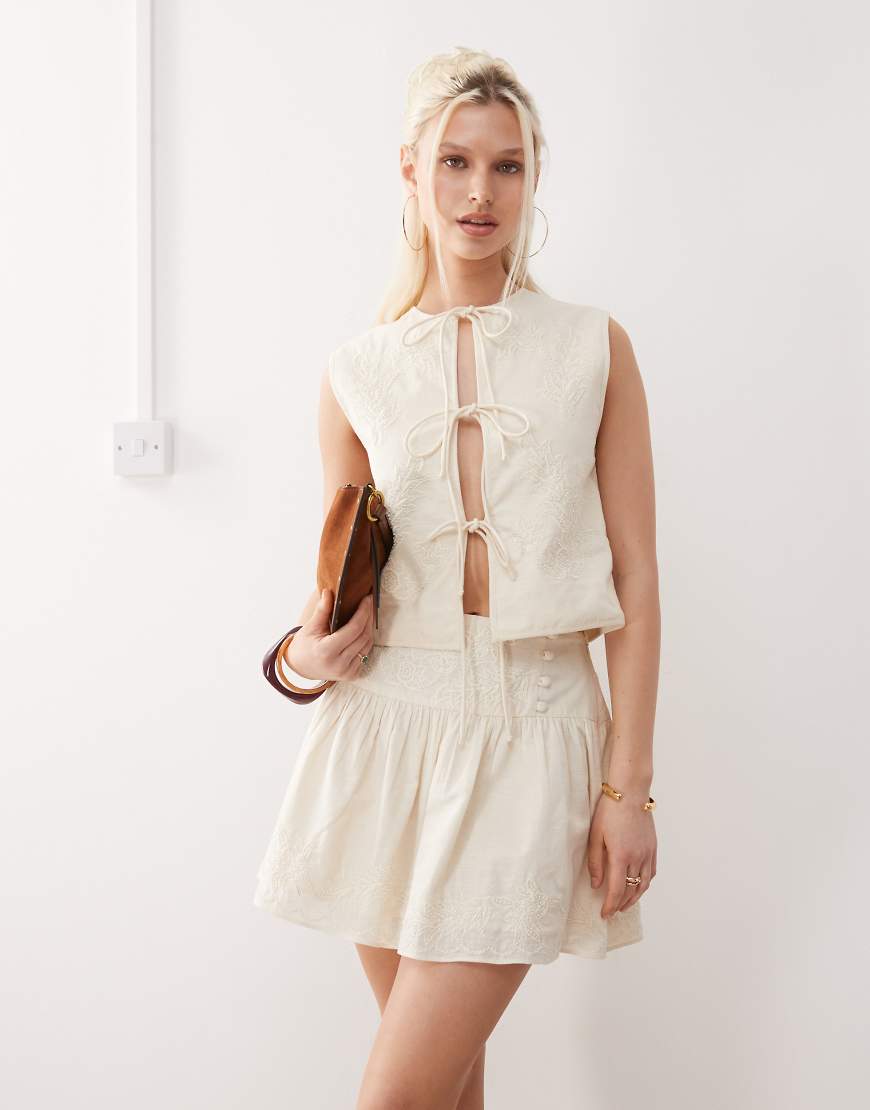 Limited Edition mini skirt with dropped waist and pearl embroidery coord-White