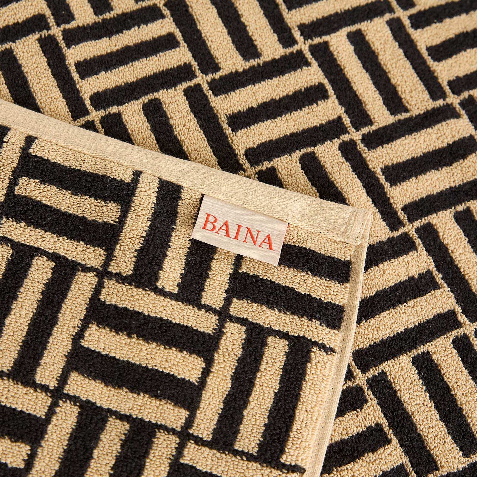 BAINA Saroma Bath Mat in Sand & Noir - Black.  a
