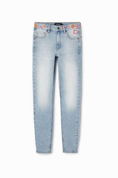 Long denim pants with flowers on the waist