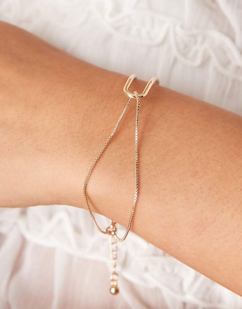 Bracelet with dainty cuff and chain detail in gold tone