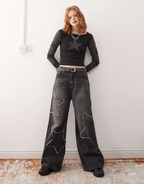 Minga London washed distressed baggy jeans with star graphic in black